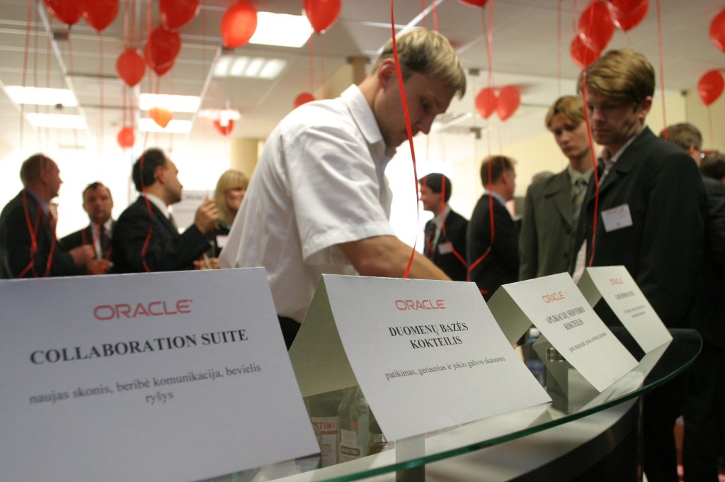 Oracle technology event in Lithuania with participants and Oracle-branded displays.